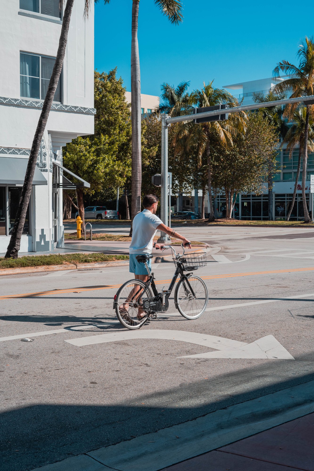 A man riding a complimentary Upsun Hotel bicycle near Ocean Drive
