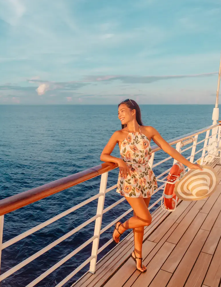Young woman enjoying the ocean view from a cruise ship deck.