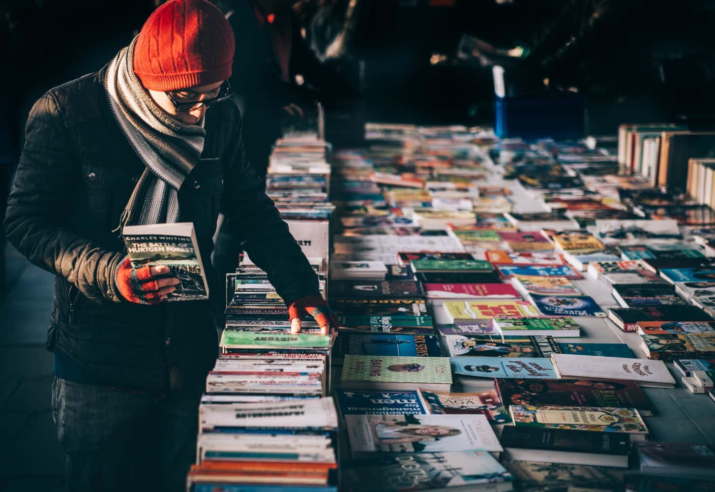 A man browsing through books in Miami Book Fair