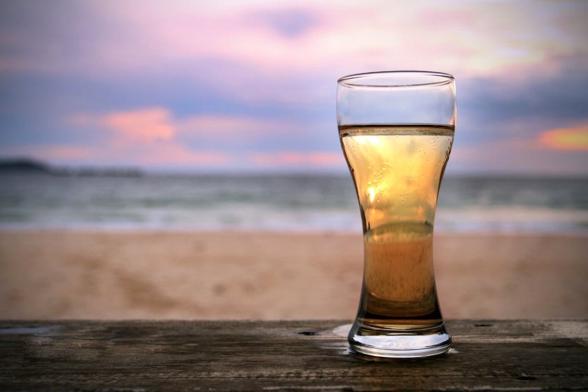 A glass of beer on the beach