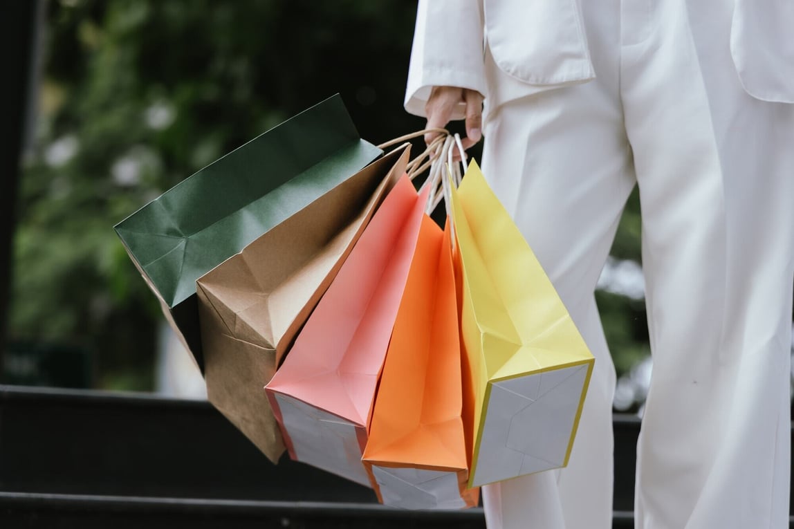 Person holding colorful shopping bags