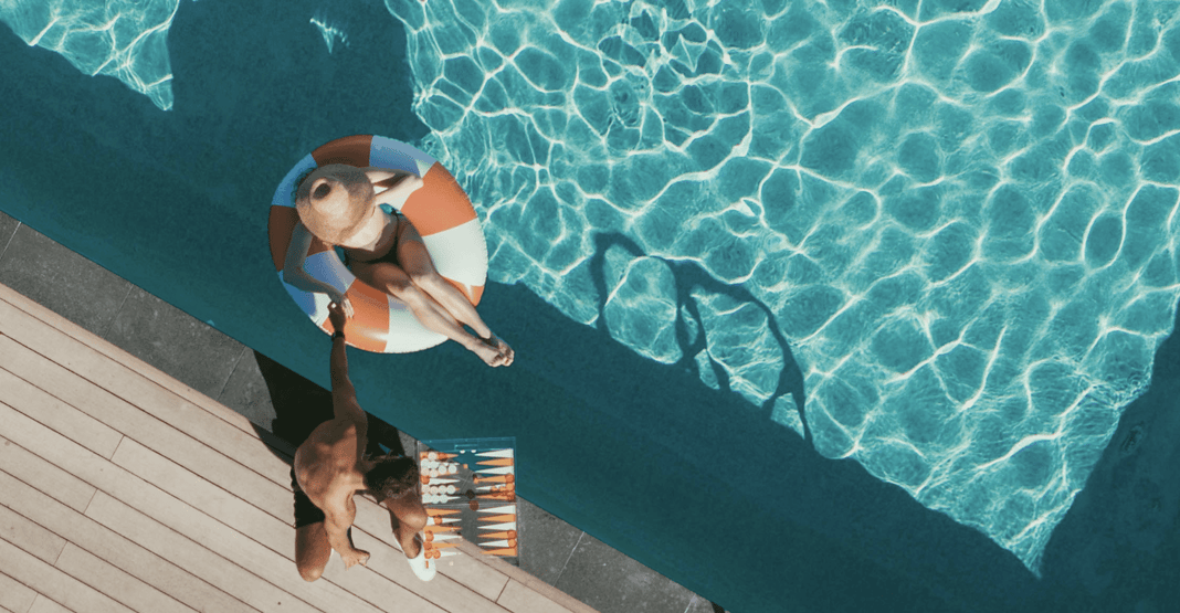 Two people enjoying Upsun's rooftop pool