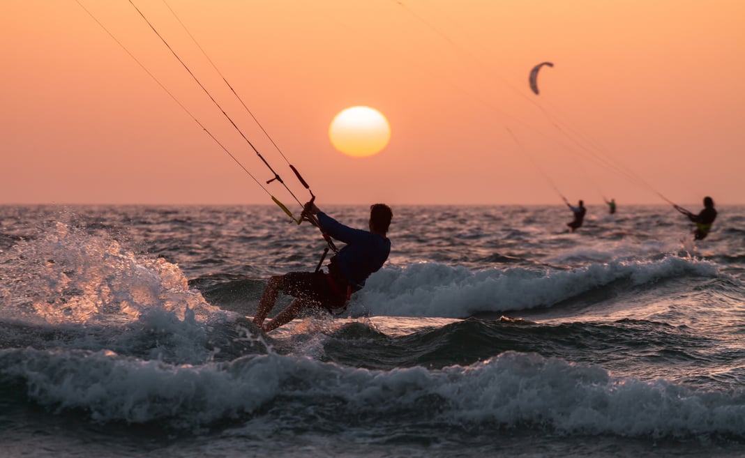 A man kitesurfing during sunset in south beach miami