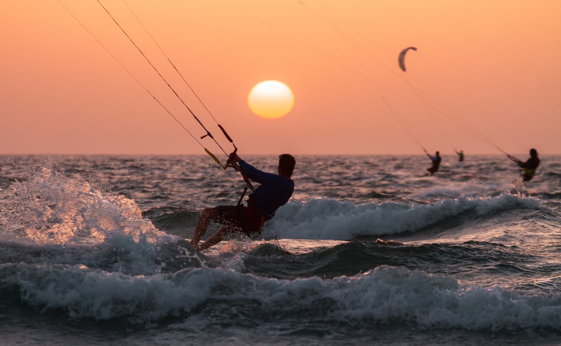 A man kitesurfing during sunset in south beach miami