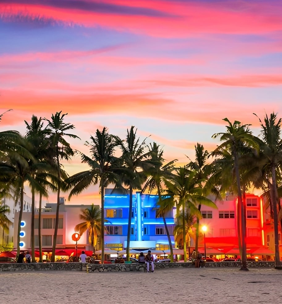 Ocean Drive Miami Beach at sunset with colorful Art Deco hotels and palm trees